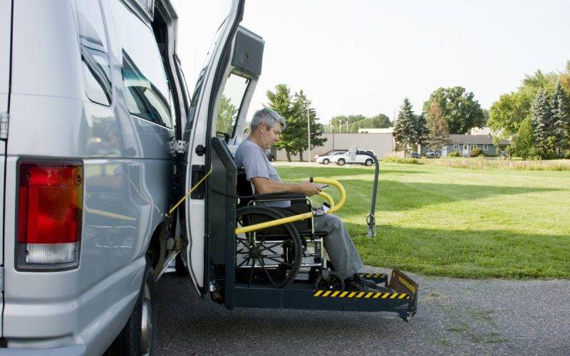 disability conversion lift van with a man in a wheelchair on the gate